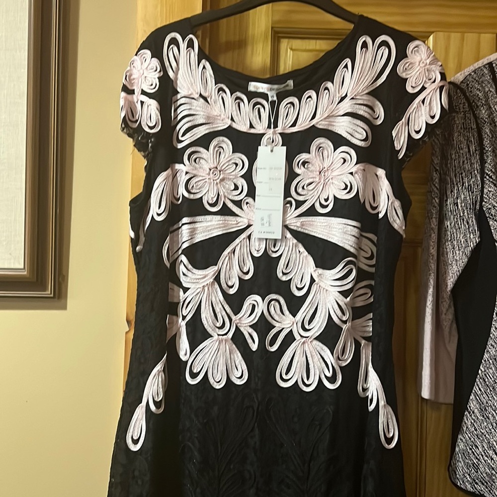 Ladies dress size 14 with tags attached.  Beautiful pink design